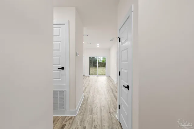 a bathroom with a glass shower door and a sink