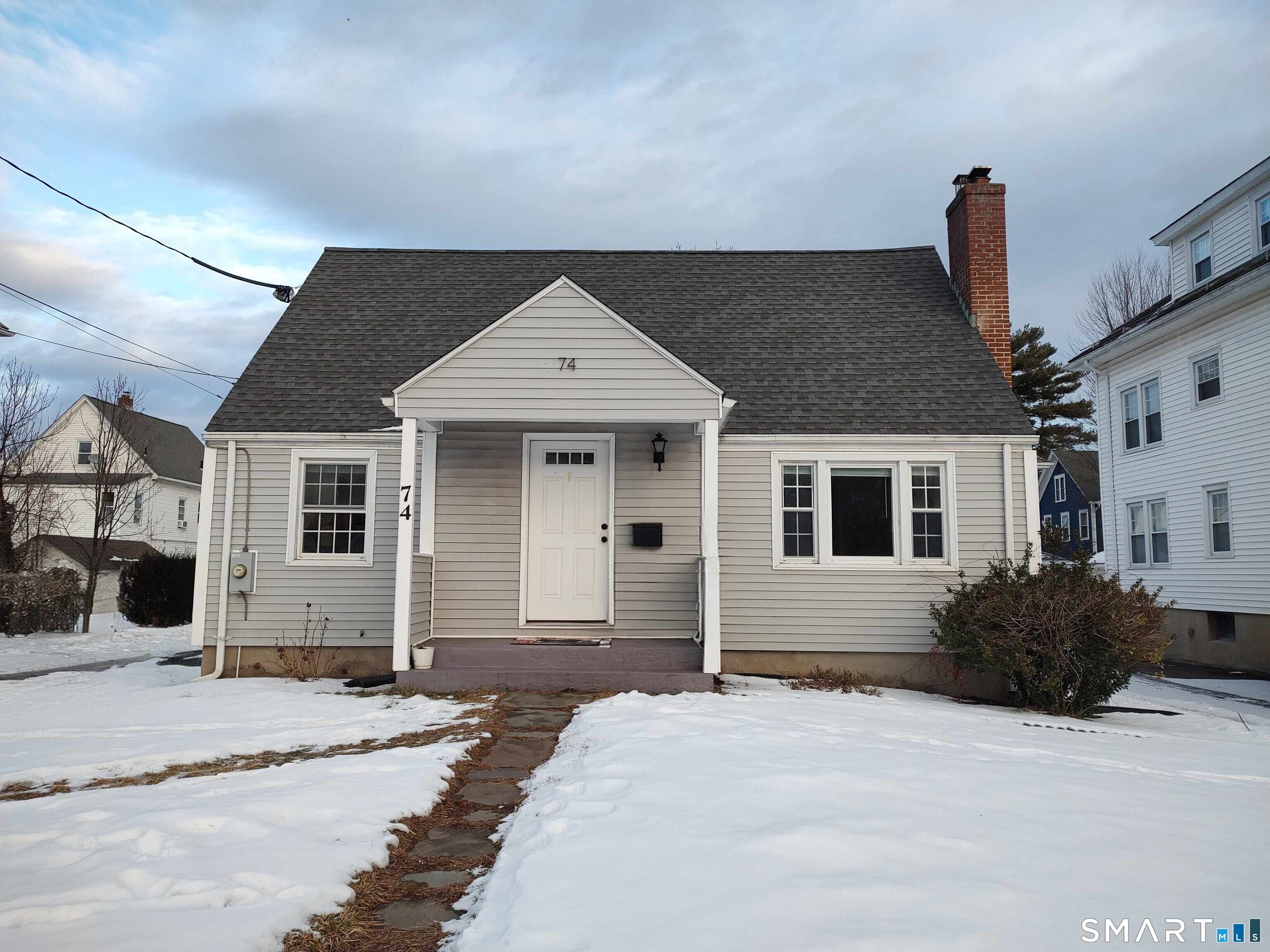 74 Lancaster Road West Hartford, CT 06119 - Photo 1 of 1 a front view of a house with a yard and garage