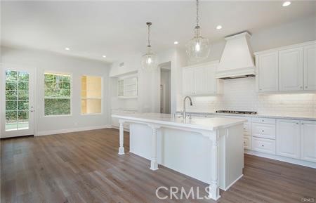 35 Winslow Street Ladera Ranch, CA 92694 - Photo 2 of 17 a kitchen with stainless steel appliances granite countertop a sink a stove a refrigerator and white cabinets with wooden floor