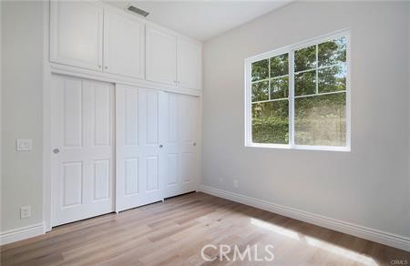 35 Winslow Street Ladera Ranch, CA 92694 - Photo 7 of 17 an empty room with wooden floor and windows