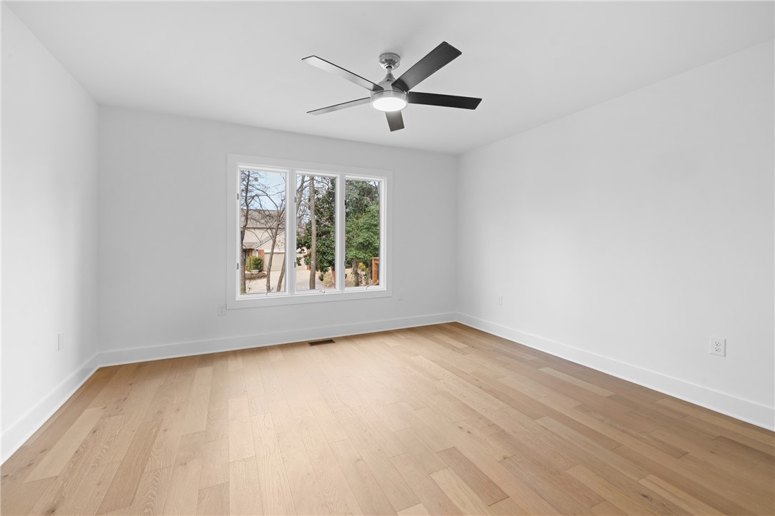 117 Riverpoint Drive Clemson, SC 29631 - Photo 27 of 47 This airy bedroom features abundant natural light and sleek hardwood floors, ready for personal touches.
