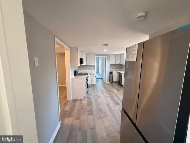 a view of hallway with wooden floor
