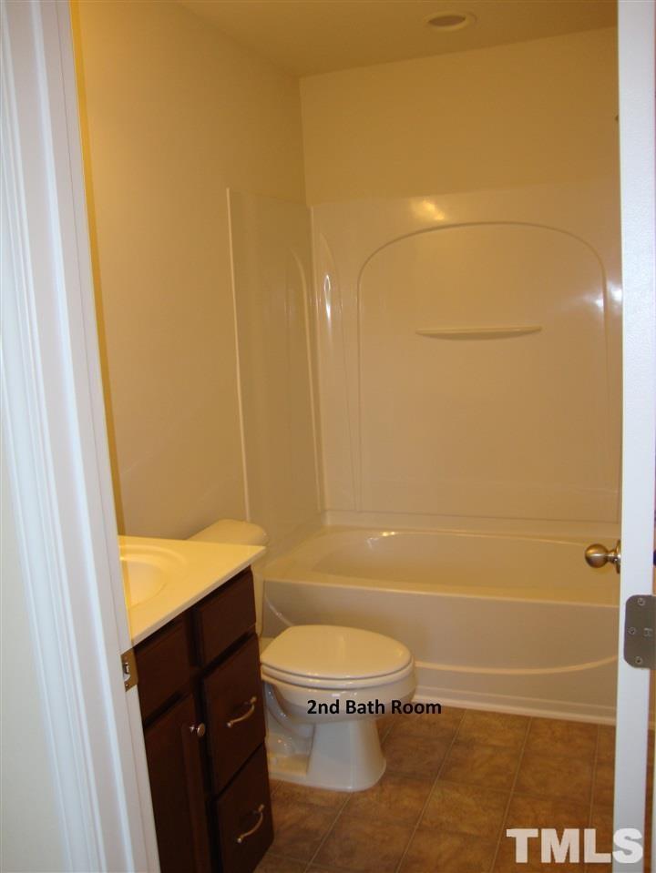 85 Intuition Circle Durham, NC 27705 - Photo 13 of 17 a bathroom with a granite countertop sink toilet and shower