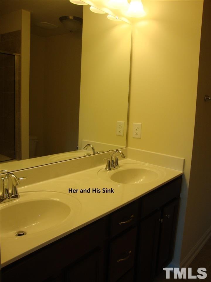 85 Intuition Circle Durham, NC 27705 - Photo 8 of 17 a bathroom with a sink and a mirror