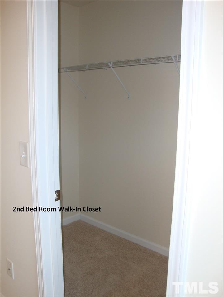 85 Intuition Circle Durham, NC 27705 - Photo 10 of 17 a view of a room with racks on the wall