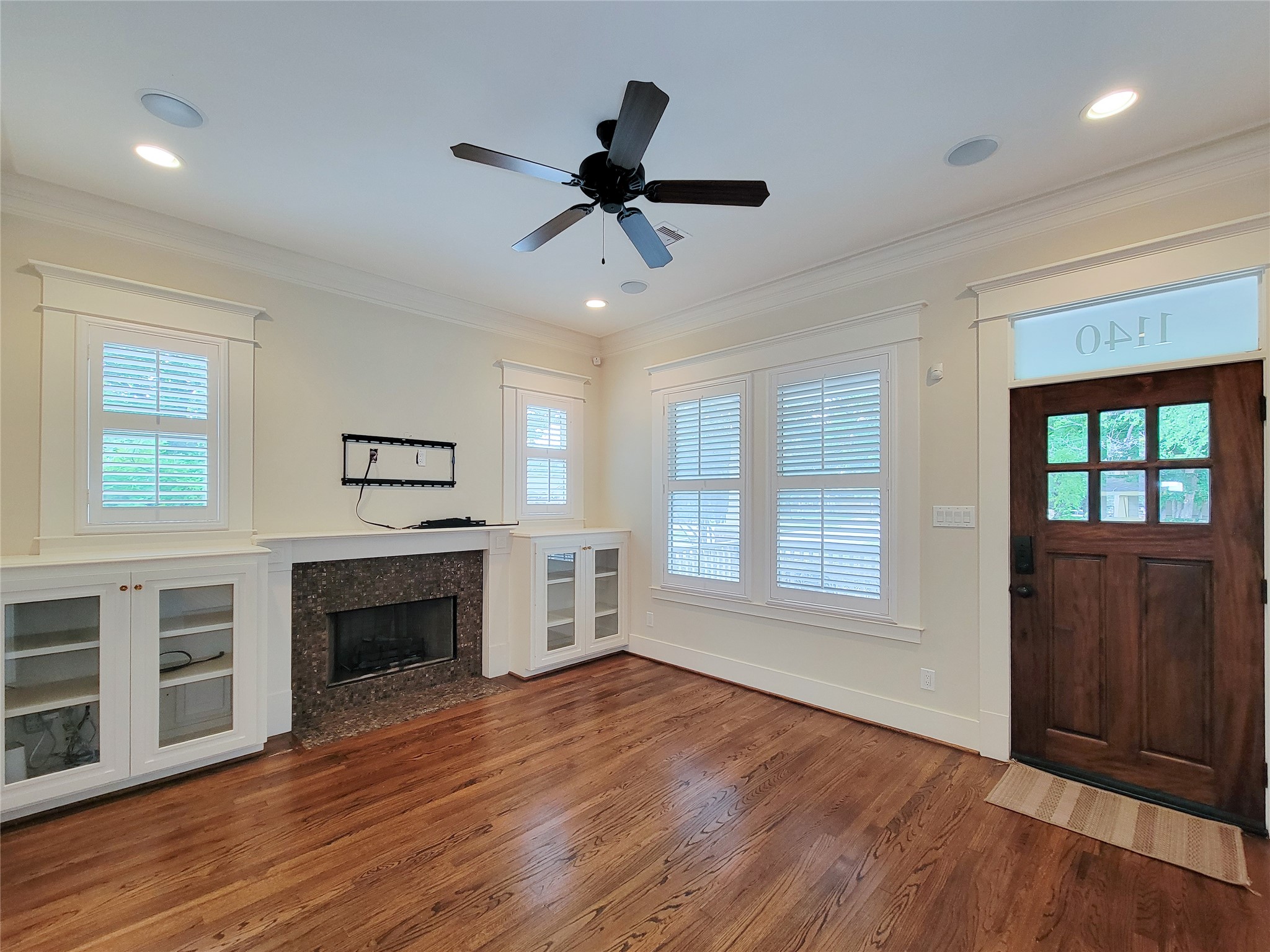 1140 West Cottage Street Houston, TX 77009 - Photo 4 of 37 a living room with wooden floors and fireplace