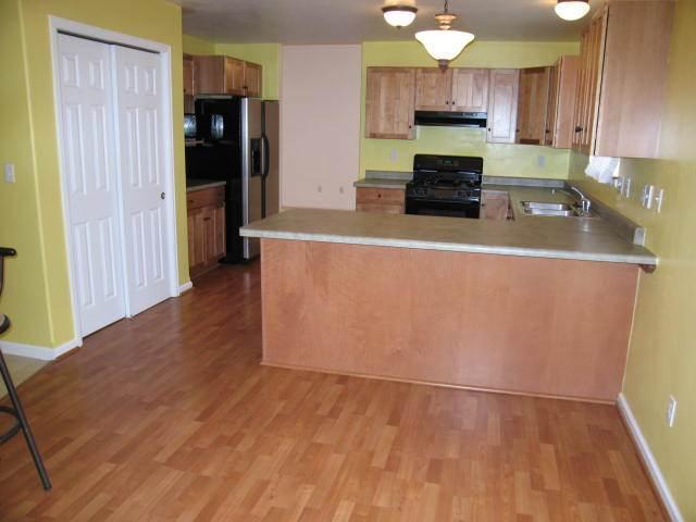 1285 East 18th Way Rifle, CO 81650 - Photo 3 of 6 a kitchen with stainless steel appliances a refrigerator and a stove top oven