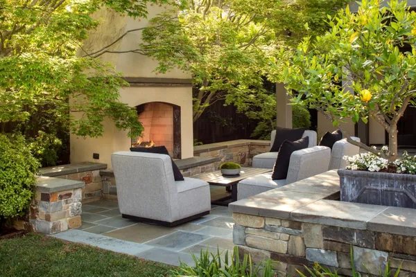 a view of a patio with couches table and chairs and potted plants