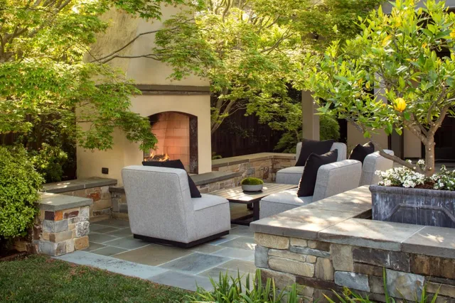a view of a patio with couches table and chairs and potted plants