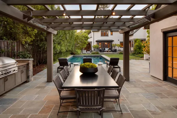a dining room with furniture and a floor to ceiling window
