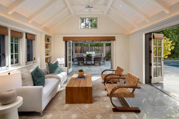 a living room with furniture a window and a floor to ceiling window