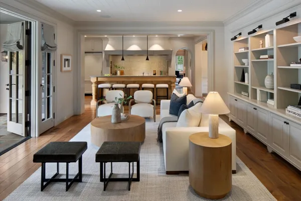 a dining room with furniture and a large window