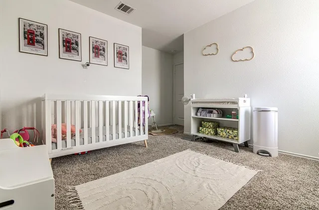 a spacious bedroom with a bed and a couch