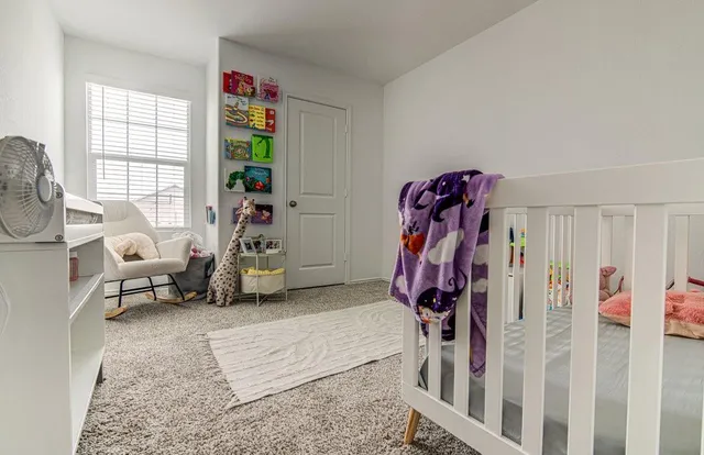 a view of a livingroom with furniture and a window