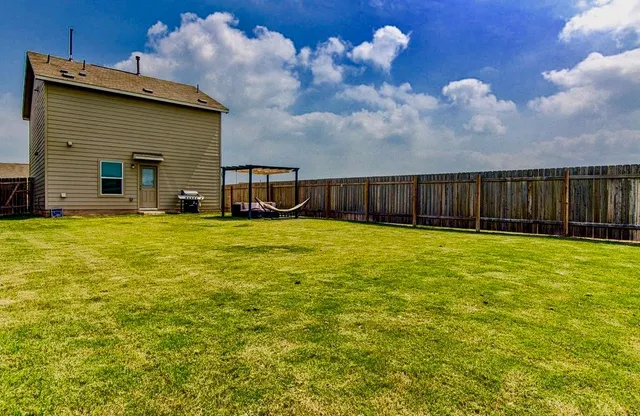 a view of a swimming pool with a yard