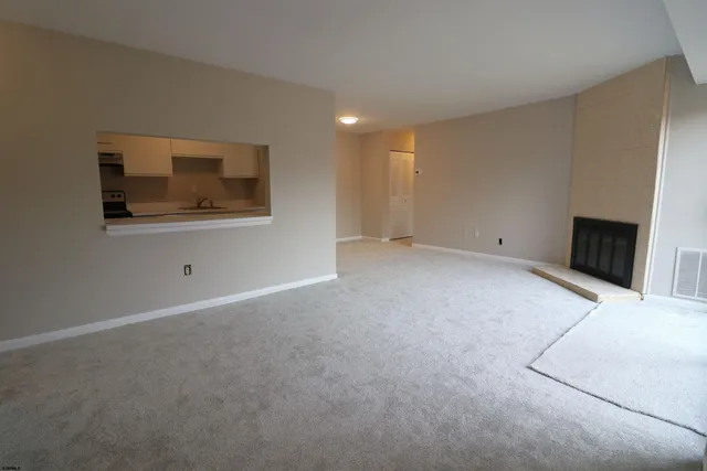 a view of an empty room with a fireplace