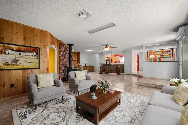a view of a dining room with furniture a chandelier and wooden floor
