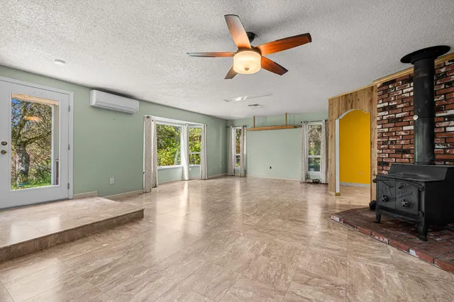 a view of a dining room with furniture a chandelier and a window