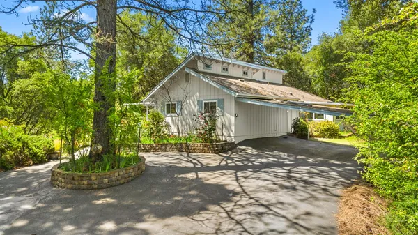 a front view of a house with a yard and a garage