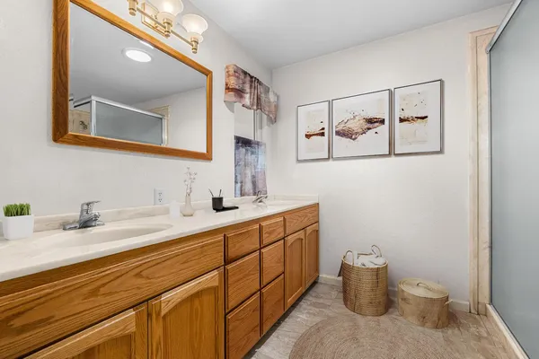a bedroom with a bed window and mirror
