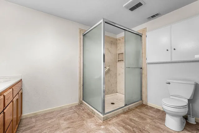a kitchen with granite countertop a sink a stove and refrigerator