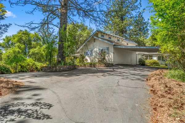 a front view of house with yard and green space