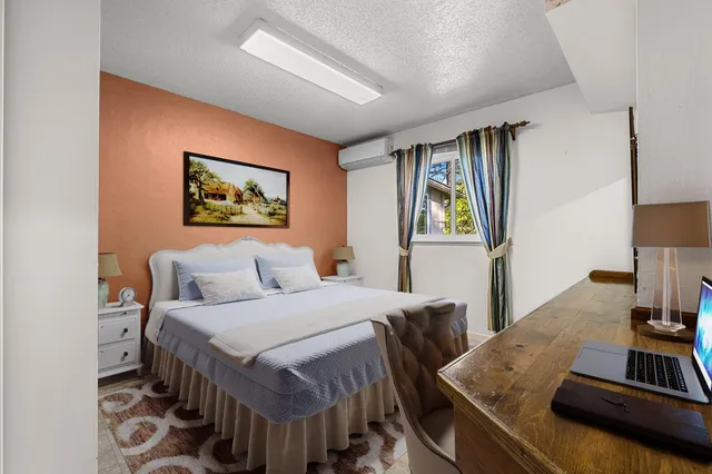 a backyard of a house with table and chairs