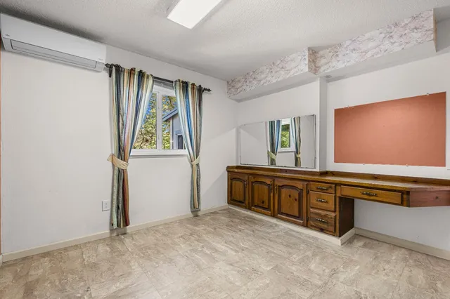 a backyard of a house with lots of green space and wooden fence