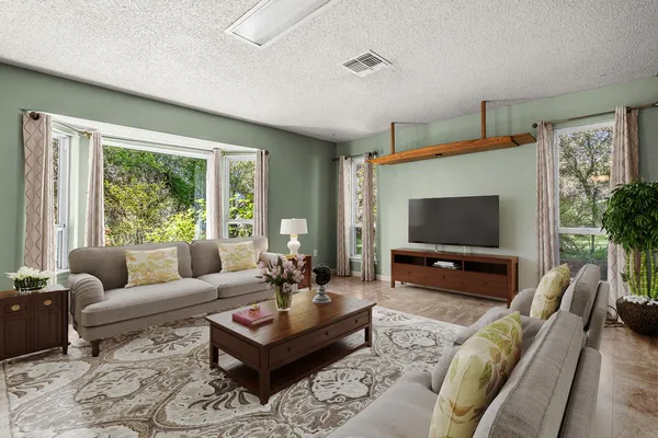 a living room with furniture fireplace and a window