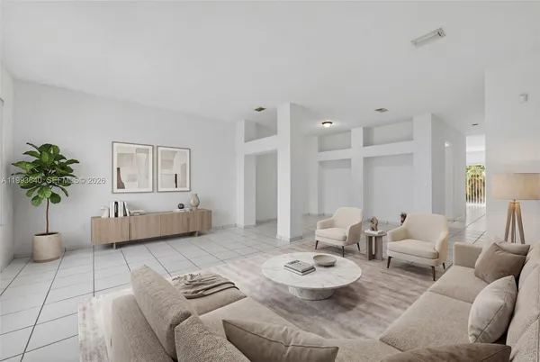 a living room with furniture ceiling fan and a window