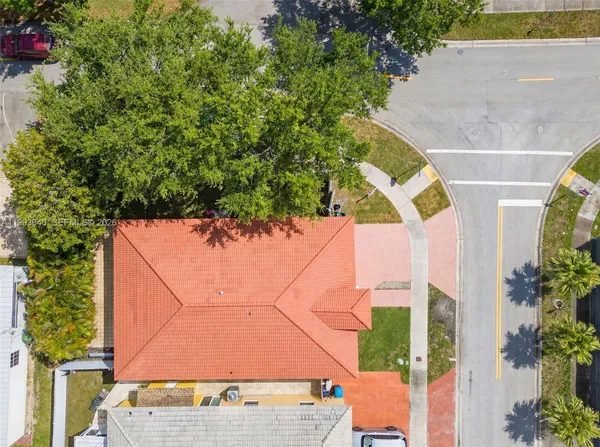 an aerial view of a house with a yard and potted plants