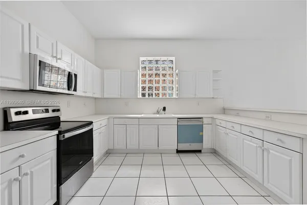 a kitchen with cabinets and stainless steel appliances