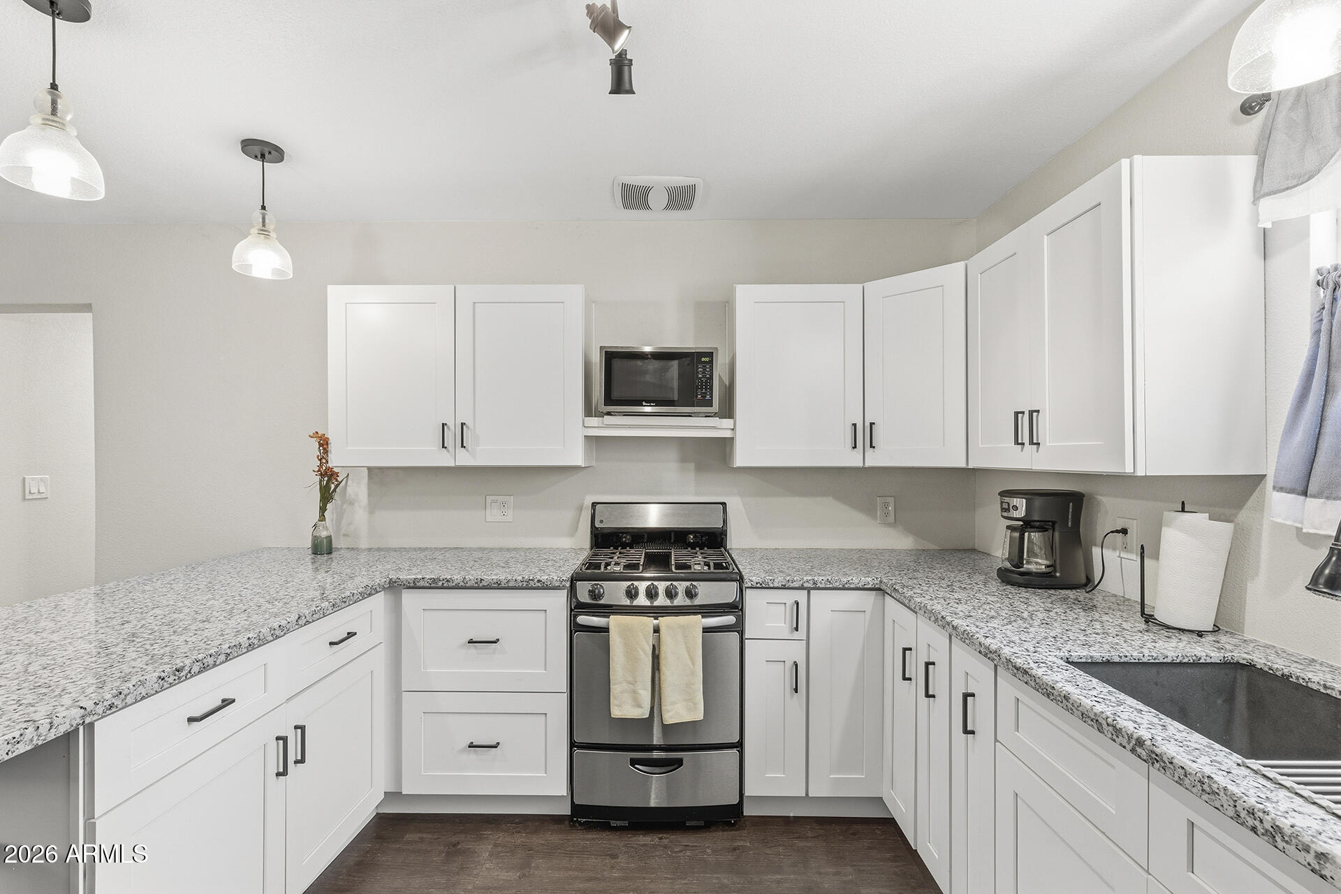 5228 North 15th Street Phoenix, AZ 85014 - Photo 75 of 96 a kitchen with granite countertop white cabinets white stainless steel appliances and sink