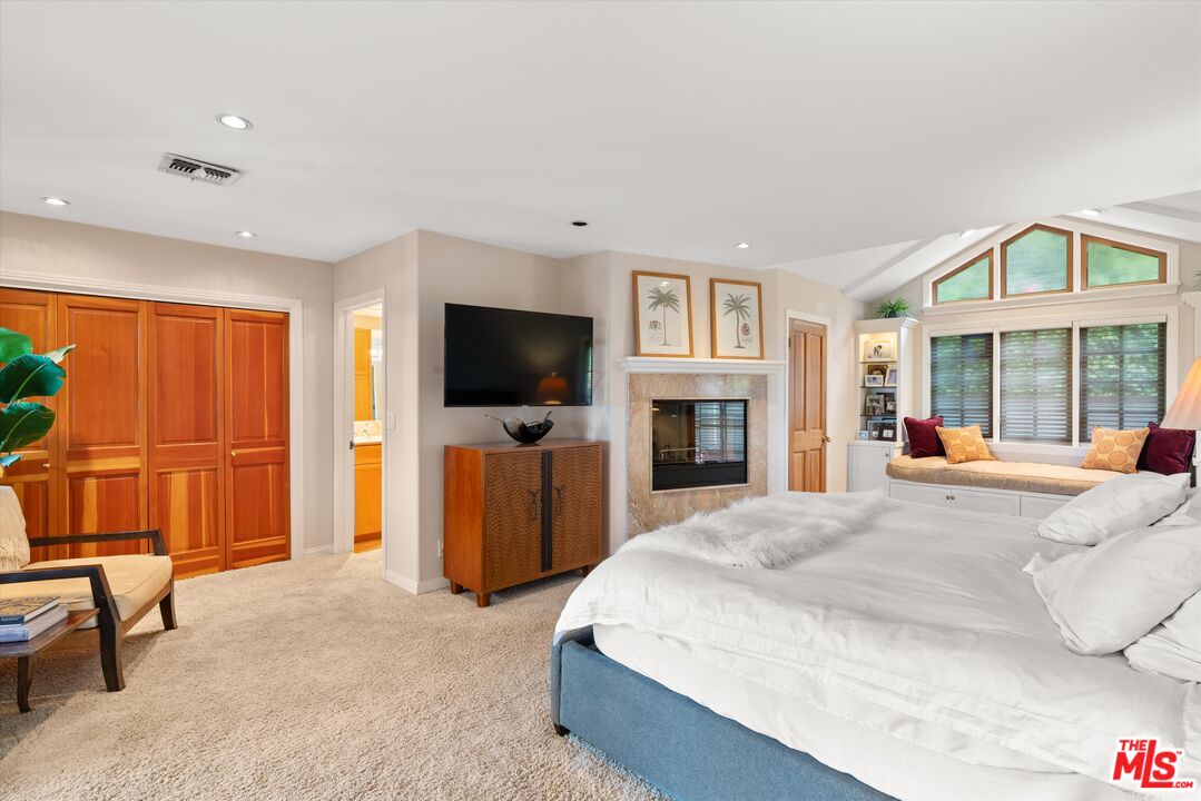 16355 Mandalay Drive Encino, CA 91436 - Photo 21 of 45 a bedroom with a bed and a flat screen tv