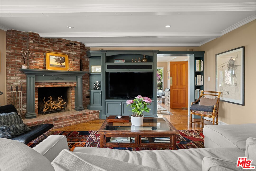 16355 Mandalay Drive Encino, CA 91436 - Photo 8 of 45 a living room with furniture fireplace and flat screen tv