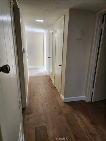 a view of a hallway with wooden floor