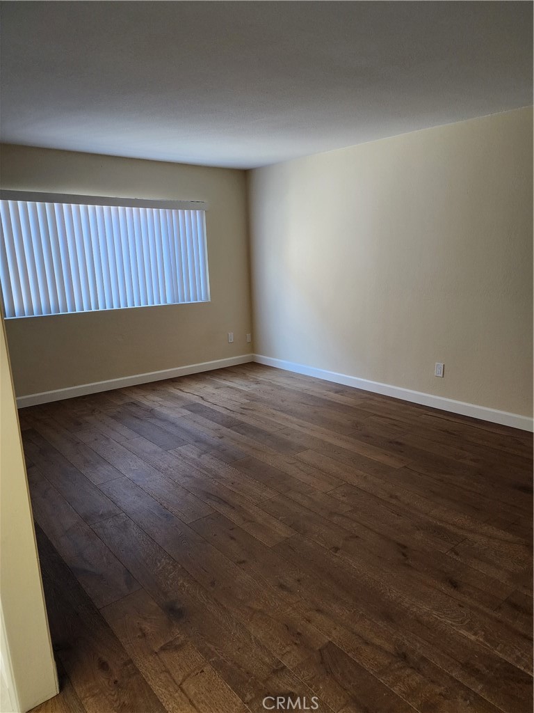 402 West Kelly Avenue, Unit A Orange, CA 92866 - Photo 6 of 13 an empty room with wooden floor and windows