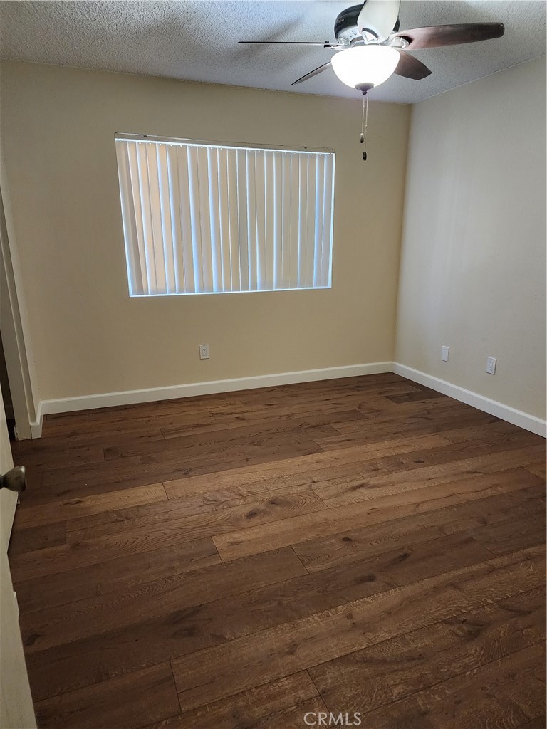402 West Kelly Avenue, Unit A Orange, CA 92866 - Photo 8 of 13 a view of an empty room with wooden floor and a chandelier