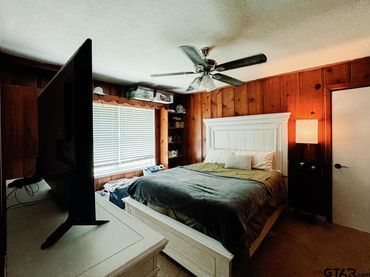 2411 Rodge Drive Tyler, TX 75701 - Photo 35 of 42 a bedroom with a bed and a ceiling fan