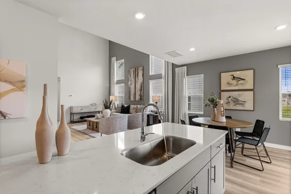 a kitchen with a sink cabinets and wooden floor