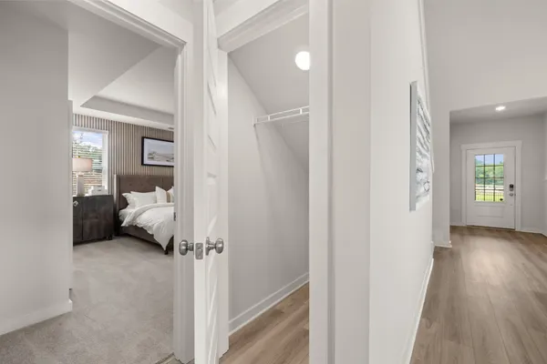 a view of a bedroom with a hardwood and hallway