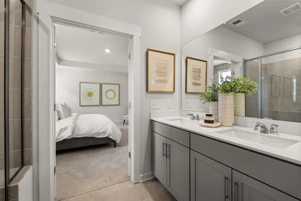 a bathroom with a shower and mirror