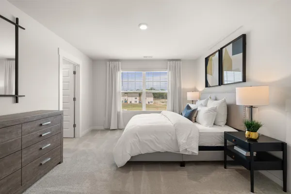 a bedroom with a bed and a lamp