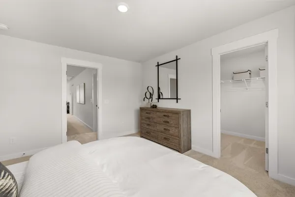 a bedroom with a bed and a night stand