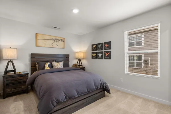 a bedroom with a bed and a lamp on table
