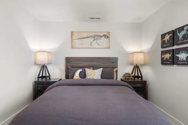 a bedroom with a bed and a view of kitchen