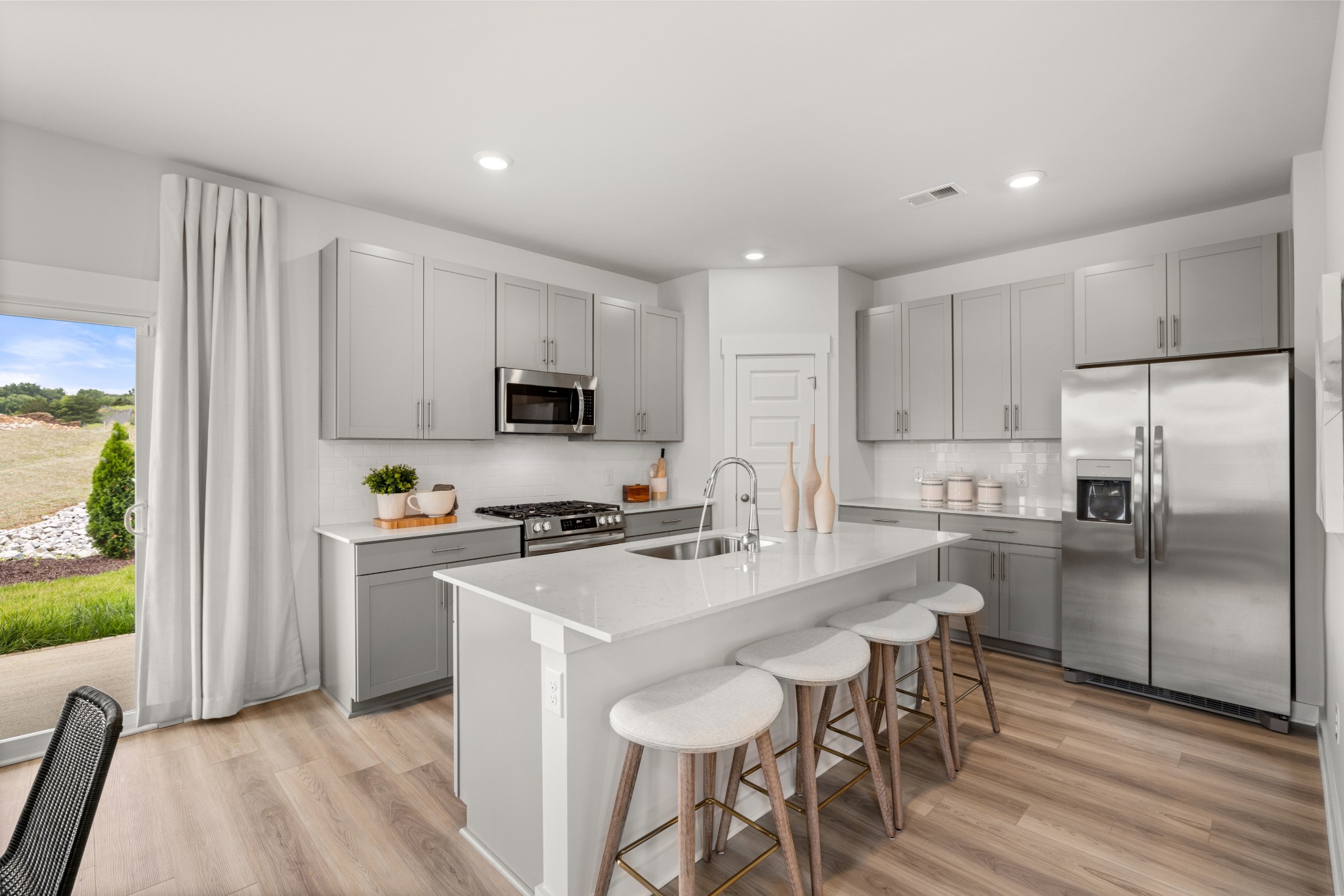 2408 Williams Rdg Drive Columbia, TN 38401 - Photo 6 of 44 a kitchen with stainless steel appliances a stove a sink a refrigerator white cabinets and wooden floor
