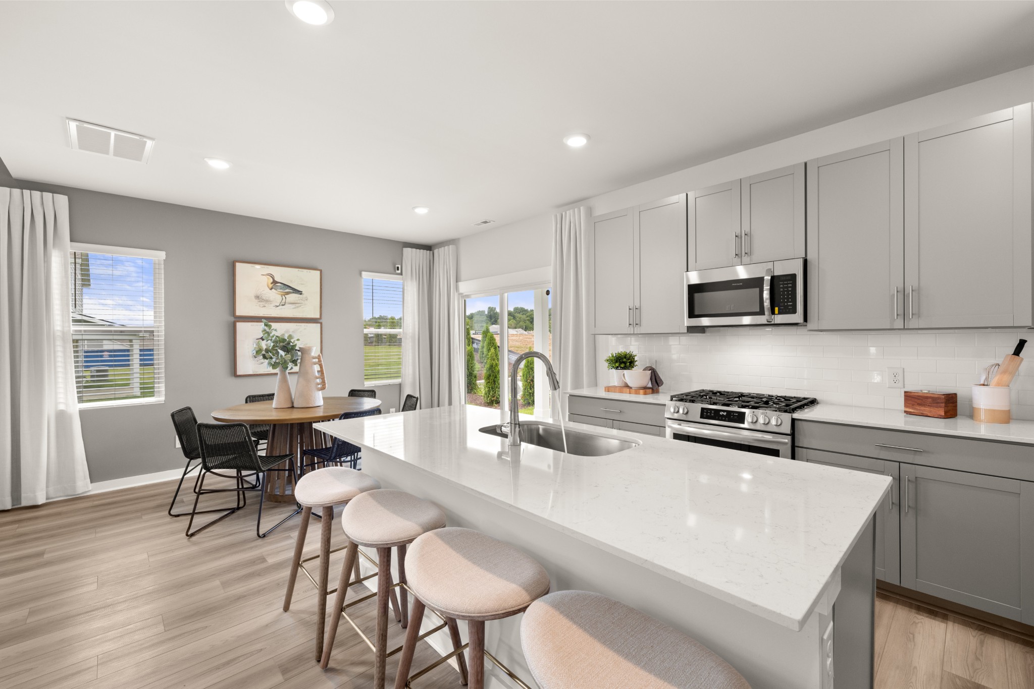 2408 Williams Rdg Drive Columbia, TN 38401 - Photo 9 of 44 a kitchen with stainless steel appliances granite countertop a stove a sink a microwave a dining table and chairs with wooden floor