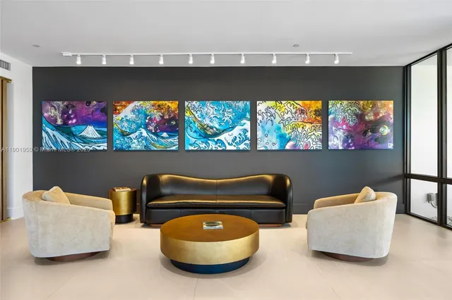 a blue and white sitting area with blue chairs