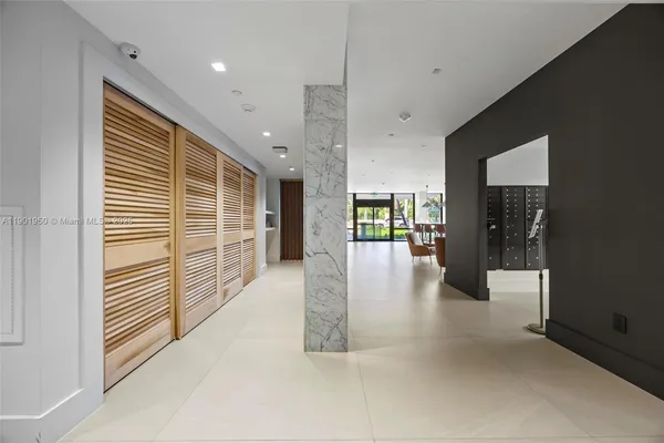 a dining room with furniture and large windows